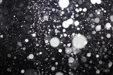 Snowfall on black background Stock Photos