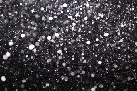 Snowfall on black background Stock Photos