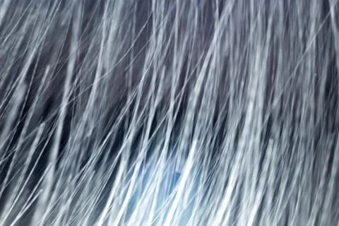 Snowfall on black background Stock Photos