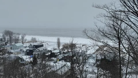 Snowfall Blankets Beach Town by Ocean Water During Winter Stock Footage 301129369