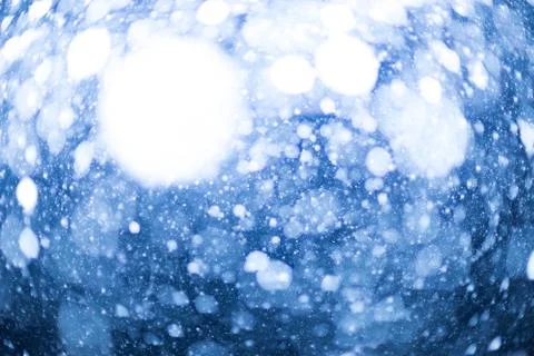 Snowfall bokeh on blue background Stock Photos