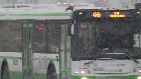 Snowfall bus turning close up Stock Footage 156596928