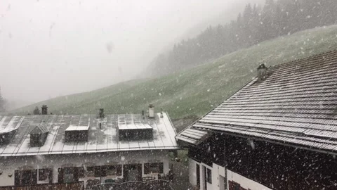 Snowfall on Cabins in the German Austrian alps Stock Footage 306679852