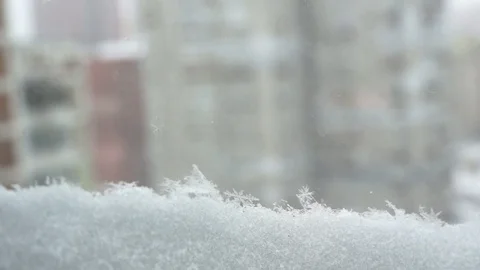 Snowfall in the city, close up view from window. Snow falling. Stock Footage 86590634