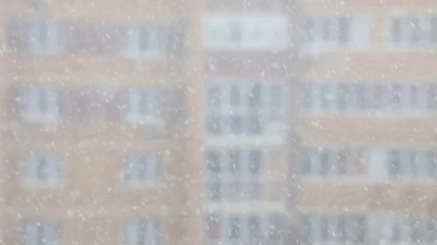 Snowfall in a city. Simple scene - falling snowflakes on a cityscape background. Stock Footage 127894415