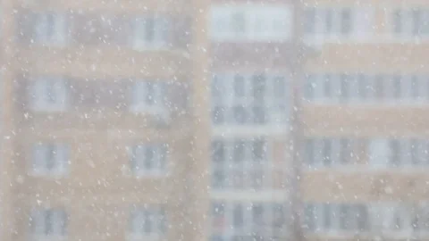 Snowfall in a city. Simple scene - falling snowflakes on a cityscape background. Stock Footage 127894444