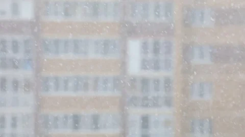 Snowfall in a city. Simple scene - falling snowflakes on a cityscape background. Stock Footage 127894446