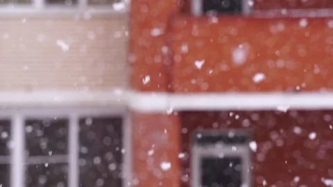 Snowfall in the city. Snowflakes fly in the background of a window on house Видео 71005560