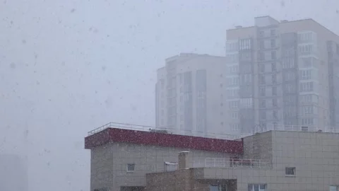 Snowfall in the city winter cold close up from the window Stock Footage 173177087