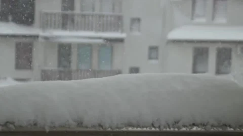 Snowfall. Close-up of a snow cap on the terrace. A view of the snow-covered Stock Footage 304877001