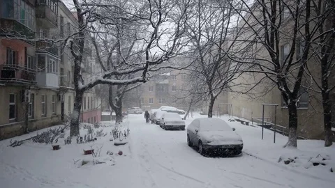 Snowfall is in the Courtyard of the Sleeping District, Covered With Snow Parked Stock Footage 71438342