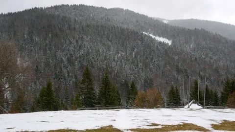 Snowfall early spring in the mountains. Horizontal panning. Stock Footage 74749729