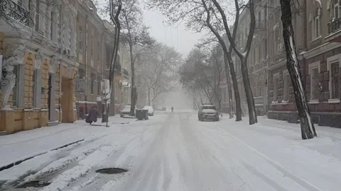 Snowfall on empty street of old city Stock Footage 142741499