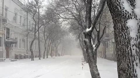 Snowfall on empty street of old city Stock Footage 142741509