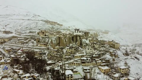 Snowfall enveloping Lamayuru Monastery captured from above. Stock Footage 310661003