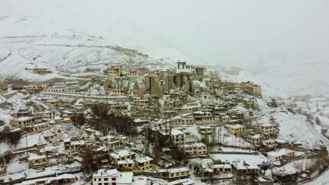 Snowfall enveloping Lamayuru Monastery captured from above. Stock Footage 310661175