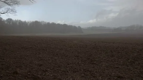 Snowfall on a field with clouds in april 5 2021 Denmark Stock Footage 151721992