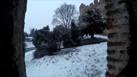 Snowfall in the garden of a medieval city Stock Footage