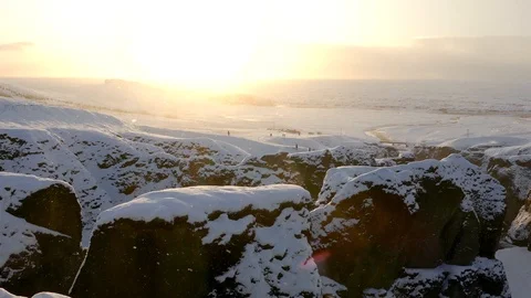 Snowfall in a glacier mountain with ray of sunlight in background Stock Footage 93968819
