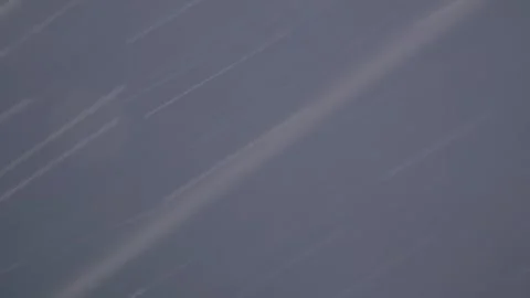 Snowfall in a Heavy Snowstorm Against Cloudy Sky Close to Camera Stock Footage 296403341