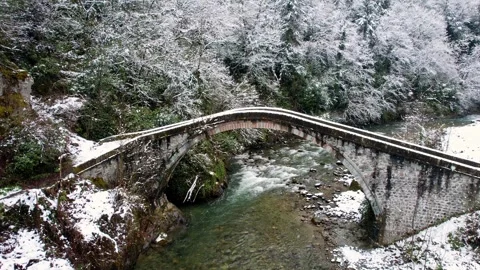 Snowfall at Historic Stone Arch Bridge i... | Stock Video | Pond5