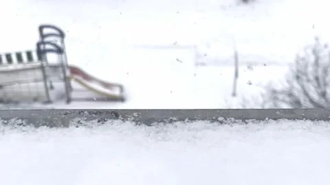 Snowfall in middle of the day. Snowflakes fall in flakes against the white sky. Stock Footage 262578366