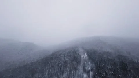 Snowfall mountain panorama with smooth fpv movement Stock Footage 321251663