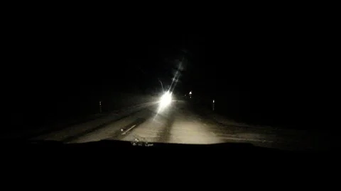 Snowfall on the night road. Video stock 122261363