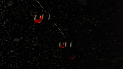 Snowfall at night in usa red traffic light Stock Footage 233480177