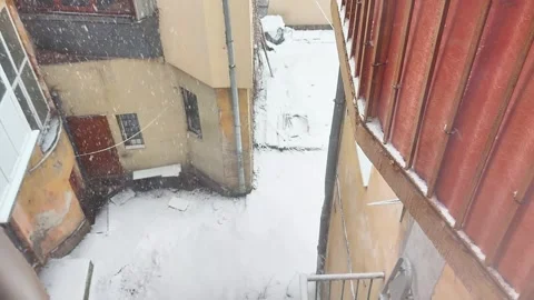 Snowfall Over Courtyard Between Colorful Buildings Viewed from Above 스톡 동영상 325491894