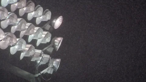 Snowfall over illuminated stadium lights Stock Footage 104769408