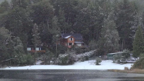 Snowfall Over Lakeside Cabin in Dense Forest, Argentine Patagonia Video stock 334157719