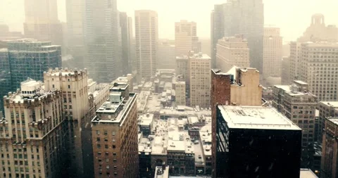 Snowfall Over Modern Cityscape Viewed from Office Window Видео 323681677