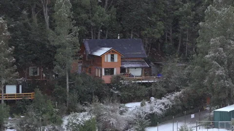 Snowfall Over a Secluded Cabin in the Forested Hills of Patagonia Vídeos de archivo 334487670