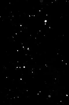 Snowfall pattern on black background, decorative winter overlay texture Stock Photos