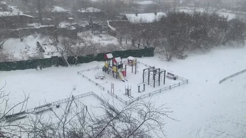 Snowfall on the playground in the city yard. Stock Footage 232487770