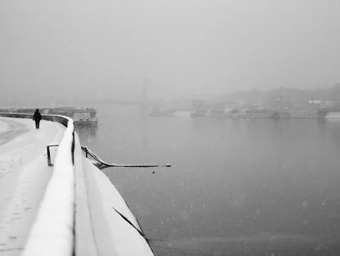 Snowfall on the river Stock Photos
