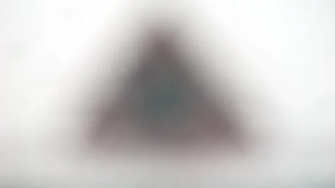 Snowfall in slow motion. Snowflakes close-up against the background of houses Stock Footage 306306473