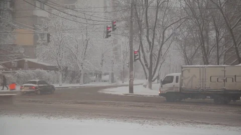 Snowfall. snow-cleaning machine cleans snow on the streets of the city Stock Footage 126596154