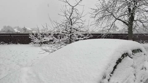 Snowfall. Snow flakes covered the parked car. the car was covered with snow. Stock Footage 232415471