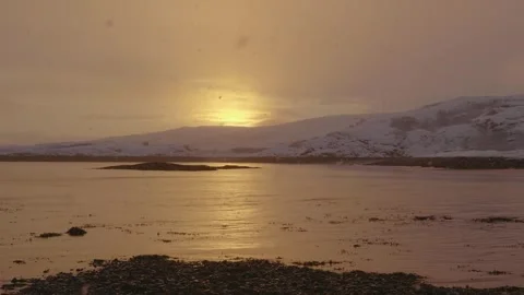 Snowfall at Sunset Over Motovsky Bay, Barents Sea, Russia: 4K Drone Footage of A Stock Footage 308925378