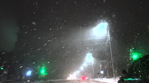 Snowfall through the windshield of a car. Snow falls on the windshield of a car Stock Footage 261222434