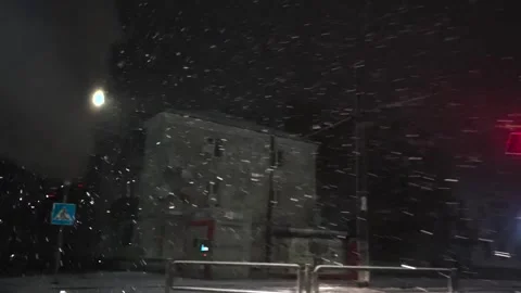 Snowfall through the windshield of a car. Snow falls on the windshield of a car Stock Footage 261222448
