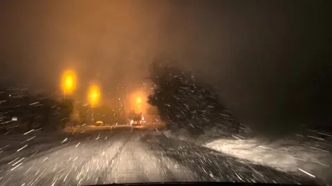 Snowfall through the windshield of a car. Snow falls on the windshield of a car Stock-Footage 262534719