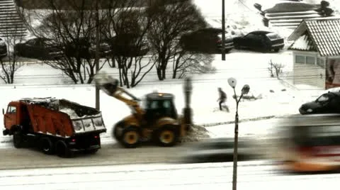 Snowfall, a tractor loads snow in the dump truck Stock Footage 22096100