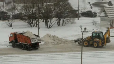 Snowfall, a tractor loads snow in the dump truck Stock Footage 22243585