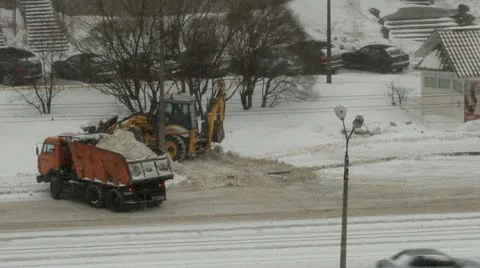 Snowfall, a tractor loads snow in the dump truck Stock-Footage 22243705