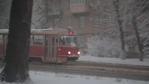 Snowfall. the tram rides on the snow-covered street in the megacity Stock-Footage 126596189