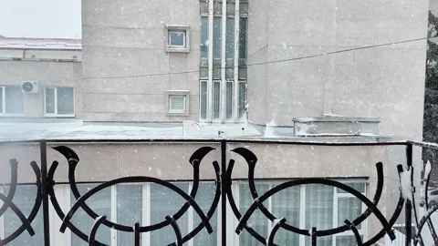 Snowfall View from Balcony Overlooking Light-Colored Urban Building Stock Footage 325491902