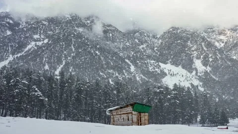 Snowfall on a vintage hut inside the mountains 4K video of snow rain Stock Footage 230909428